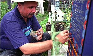 Ioan Patras painting a cross.